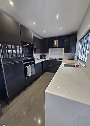 High-end kitchen renovation with polished marble worktop by Villa Renovations